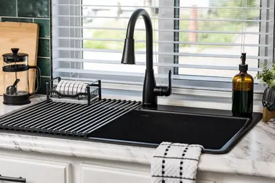 a kitchen sink with a metal grate over it at Denver Emerald - Close to Red Rocks, Arvada & Downtown in Denver