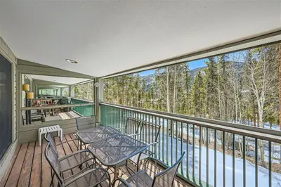 a balcony with a table and chairs on it at 2509 Saints John condo in Keystone