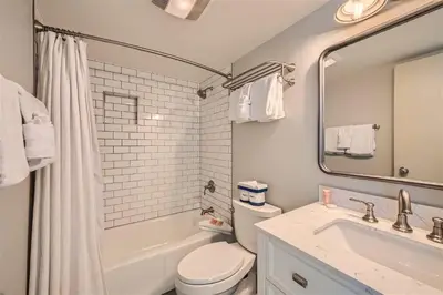 a bathroom with a toilet and a sink and a mirror at 2509 Saints John condo in Keystone