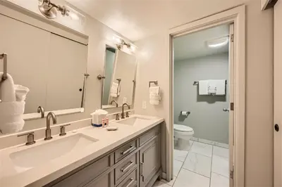 a bathroom with two sinks and a toilet at 2509 Saints John condo in Keystone