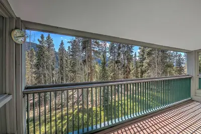 a balcony with a view of the woods at 2509 Saints John condo in Keystone