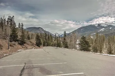 an empty parking lot with mountains in the background at 2509 Saints John condo in Keystone