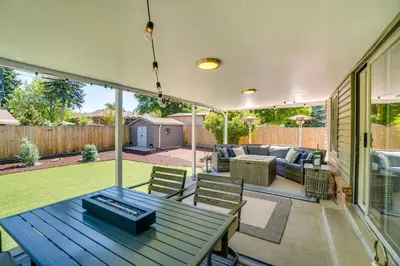 a screened in patio with a blue table and chairs at Covered Patio and Fire Pit Centennial Home! in Centennial