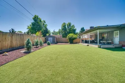 a yard with a fence and a house at Covered Patio and Fire Pit Centennial Home! in Centennial