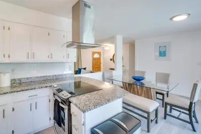 a kitchen with white cabinets and a counter top at Covered Patio and Fire Pit Centennial Home! in Centennial