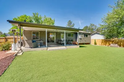 a home with a large lawn in front of it at Covered Patio and Fire Pit Centennial Home! in Centennial