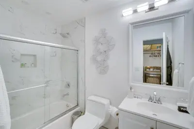 a bathroom with a toilet and a sink and a shower at Covered Patio and Fire Pit Centennial Home! in Centennial