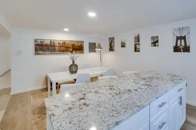 a kitchen and dining room with a marble counter top at Sleek and Central Centennial Apartment with Fireplace! in Centennial