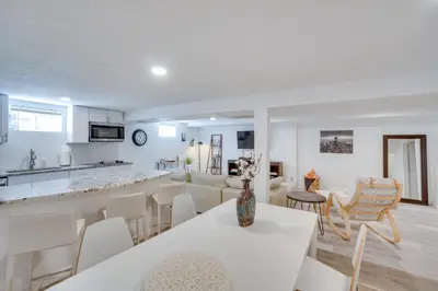 a kitchen and living room with a table and chairs at Sleek and Central Centennial Apartment with Fireplace! in Centennial