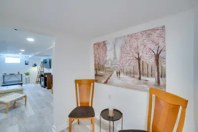 a room with two chairs and a painting on the wall at Sleek and Central Centennial Apartment with Fireplace! in Centennial