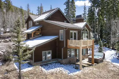 a house with a deck in the snow at 103 Antler Way at Lakota townhouse in Winter Park