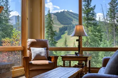 a living room with a large window with a view of a mountain at 103 Antler Way at Lakota townhouse in Winter Park