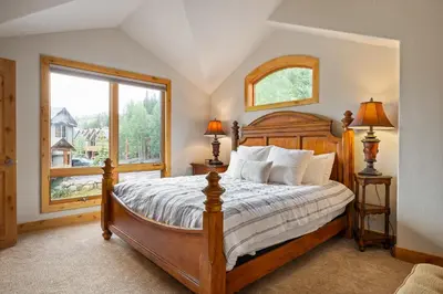 a bedroom with a bed and a large window at 103 Antler Way at Lakota townhouse in Winter Park