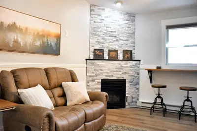 a living room with a couch and a fireplace at Mount Chiquita Suite in Estes Park