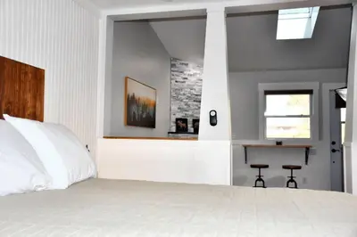 a bedroom with a white bed and a window at Mount Chiquita Suite in Estes Park