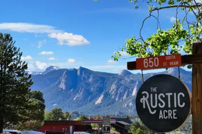 a sign for the rustic area with mountains in the background at Mount Chiquita Suite in Estes Park