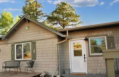a house with two chairs and a white door at Mount Chiquita Suite in Estes Park