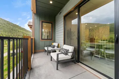 a balcony with chairs and a table with a view at Clearwater Lofts 205 Building 3 in Keystone
