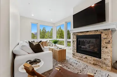 a living room with a fireplace and a tv at Clearwater Lofts 205 Building 3 in Keystone