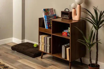 a book shelf with books and a dog bed at NEW Modern, Luxury Home with Hot Tub, Gym, Sauna, and 12 Minutes to Denver in Arvada