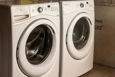 a washing machine and a dryer sitting next to each other at NEW Modern, Luxury Home with Hot Tub, Gym, Sauna, and 12 Minutes to Denver in Arvada