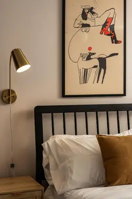 a bedroom with a bed with a picture on the wall at NEW Modern, Luxury Home with Hot Tub, Gym, Sauna, and 12 Minutes to Denver in Arvada