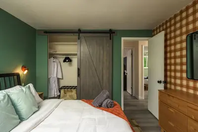 a bedroom with a bed and a sliding glass door at NEW Modern, Luxury Home with Hot Tub, Gym, Sauna, and 12 Minutes to Denver in Arvada
