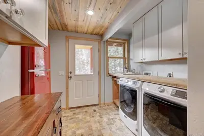 a kitchen with a washer and dryer in it at House of The Rising Sun in Bailey