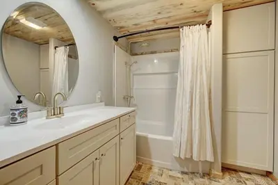 a bathroom with a sink and a mirror and a tub at House of The Rising Sun in Bailey
