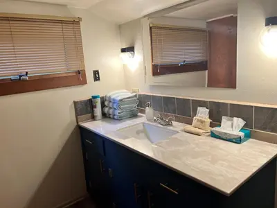 a bathroom with a sink and a mirror at Rose Den - Romantic Mountain Cabin with Views! in Estes Park