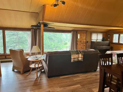 a living room with a couch and a table at Rose Den - Romantic Mountain Cabin with Views! in Estes Park