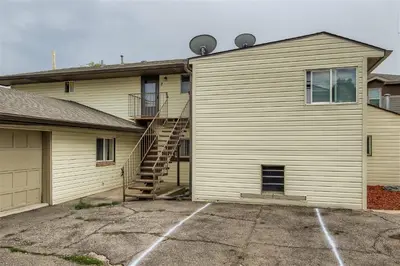 a house with a staircase next to a garage at Natural Light, High-Vaulted Ceilings Apartment and Garage in Lakewood