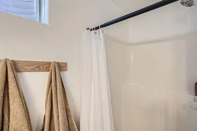 a shower curtain is hanging in a bathroom at Serene, Spacious Home in Quiet Neighborhood with Fenced Yard in Aurora