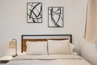 a bedroom with three black and white art above a bed at Serene, Spacious Home in Quiet Neighborhood with Fenced Yard in Aurora