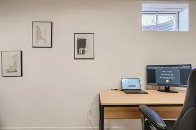 a desk with a computer and a laptop on it at Serene, Spacious Home in Quiet Neighborhood with Fenced Yard in Aurora