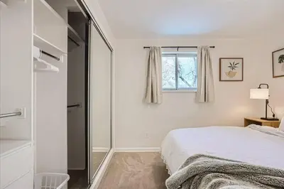 a bedroom with a bed and a glass shower at Serene, Spacious Home in Quiet Neighborhood with Fenced Yard in Aurora