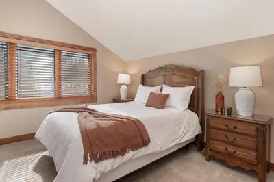 a bedroom with a large bed and a window at Stagecoach Cabin home in Fraser