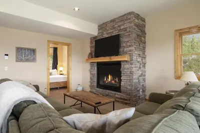 a living room with a couch and a fireplace at Grand Chalet at Grand Lake cabin in Grand Lake