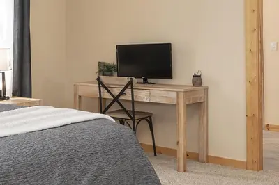 a bedroom with a desk with a television on it at Grand Chalet at Grand Lake cabin in Grand Lake