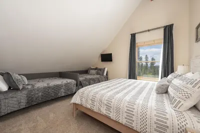 a bedroom with two beds and a window at Grand Chalet at Grand Lake cabin in Grand Lake