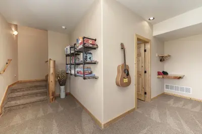 a room with a guitar hanging on the wall at Grand Chalet at Grand Lake cabin in Grand Lake