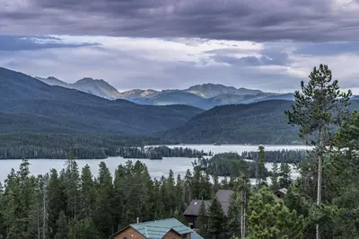 a view of a lake with mountains in the background at Grand Chalet at Grand Lake cabin in Grand Lake