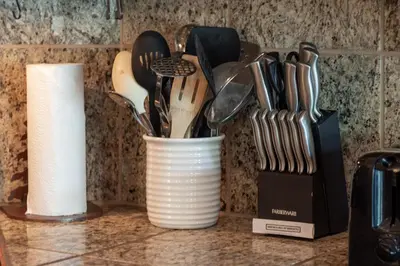 a white cup filled with utensils on a counter at Iron Horse C4093 condo in Winter Park