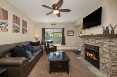 a living room with a couch and a fireplace at Base Camp 313 condo in Granby