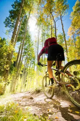 a person riding a bike on a dirt road at Base Camp 313 condo in Granby