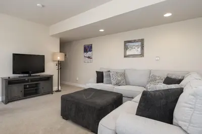 a living room with a couch and a flat screen tv at Peak View Drive townhouse in Granby