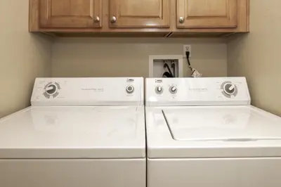 two white machines sitting next to each other in a kitchen at Peak View Drive townhouse in Granby