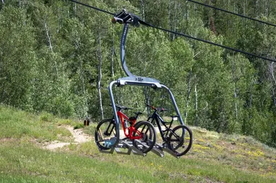 a bike is hanging from a ski lift at Peak View Drive townhouse in Granby