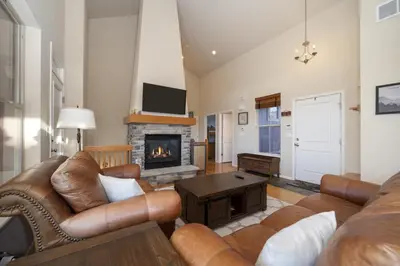 a living room with a couch and a fireplace at Peak View Drive townhouse in Granby