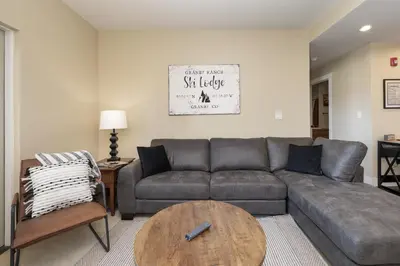 a living room with a couch and a table at Base Camp 306 condo in Granby